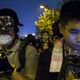 Protesters look their phones as they block the entrance to the offices of Hong Kong's Chief Executive Leung Chun-ying in Hong Kong October 2, 2014. Hong Kong authorities on Thursday urged thousands of pro-democracy protesters to immediately end their blockade of the city centre and said any attempt to occupy administrative buildings would be met with a resolute and firm response. REUTERS/Tyrone Siu